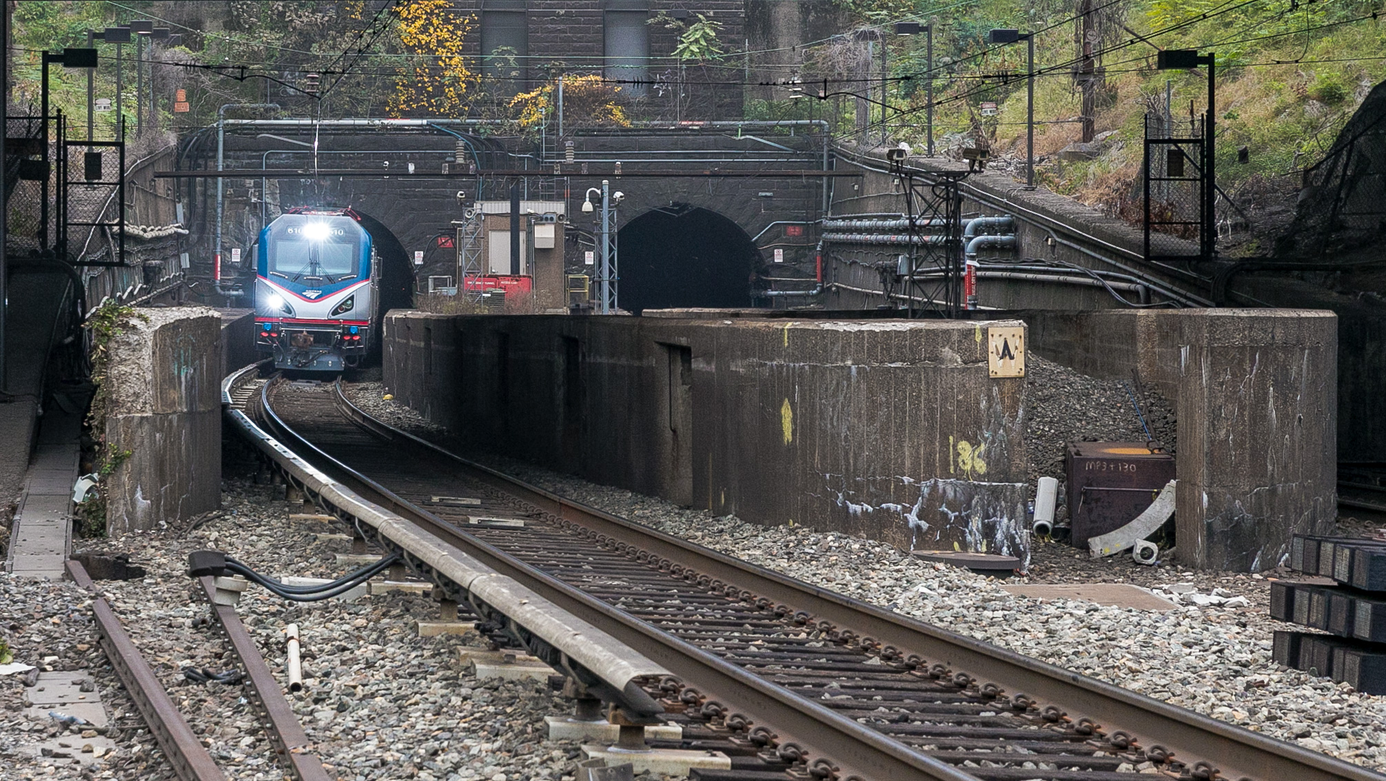 An Amtrak train exits the north tube of the Hudson River Tunnel on its way to New Jersey from New York