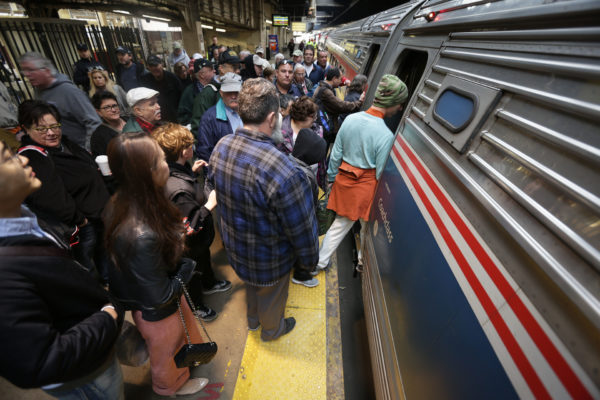 Dozens of passengers prepare to board the Autumn Express at Newark Penn Station.