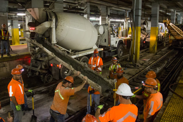 Amtrak crews pour concrete at New York Penn Station