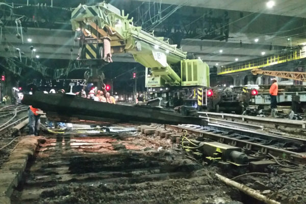 Amtrak’s 125-ton dual telescopic rail crane removing existing switch panels for replacement.