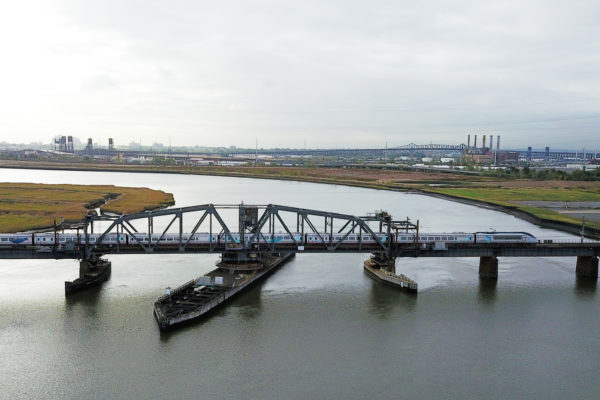 An Amtrak Acela train travels over Portal Bridge, a two-track, 110-year-old swing span structure over the Hackensack River in Kearney and Secaucus, New Jersey known for malfunctioning and causing delays on the Northeast Corridor.

Photo Credit: Governor Chris Christie’s Office/Tim Larsen