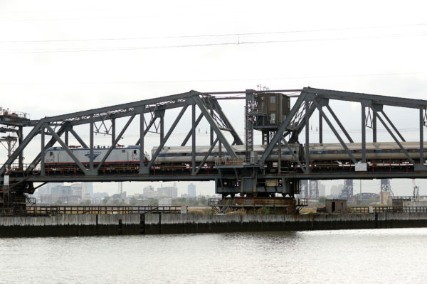 An Amtrak Northeast Regional train travels over Portal Bridge, a two-track, 110-year-old swing span structure over the Hackensack River in Kearney and Secaucus, New Jersey known for malfunctioning and causing delays on the Northeast Corridor.

Photo Credit: Governor Chris Christie's Office/Tim Larsen