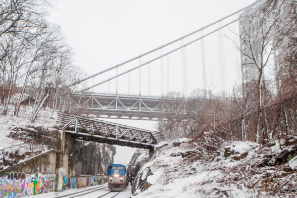 An Empire Service train passes under the George Washington Bridge in Manhattan.