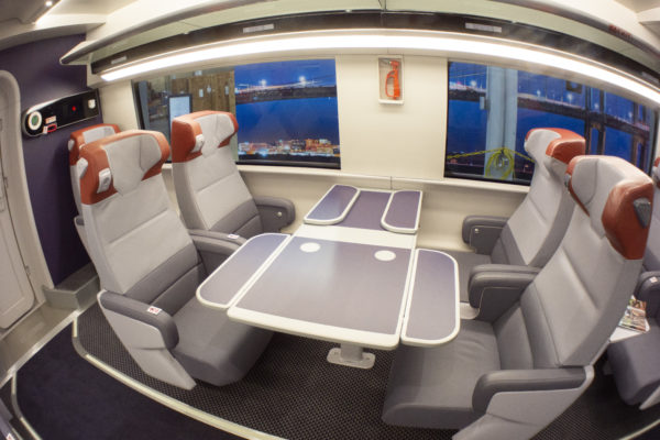 The First-Class car features larger seats with more space and extra leg room.