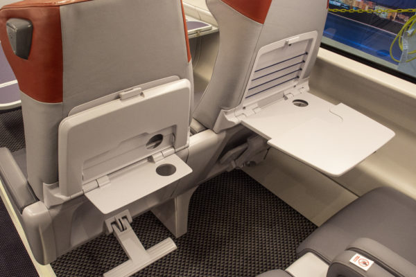 Each seat back is equipped with dual tray tables providing customers with 
a large and small table option.