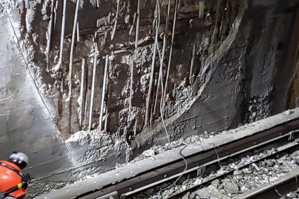 Crews use a jackhammer to loosen and remove unstable concrete on the benchwall during a recent 55-hour weekend outage in the more than a century-old North River Tunnel.