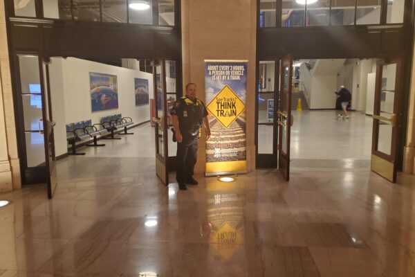 Law enforcement office with See Tracks? Think Trains banner in Chicago Union Station