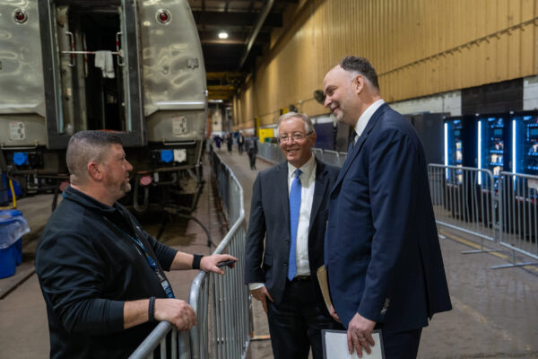 Amtrak CEO Stephen Gardner and Amtrak Board Chair Tony Coscia speak with an employee from our maintenance facility in Bear, Delaware.