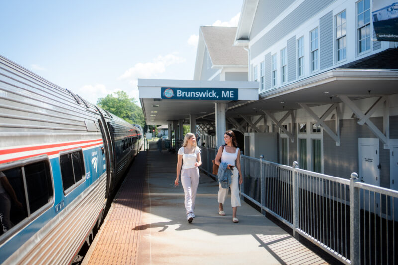 Two customers walking on the platform at the Brunswick Amtrak Station