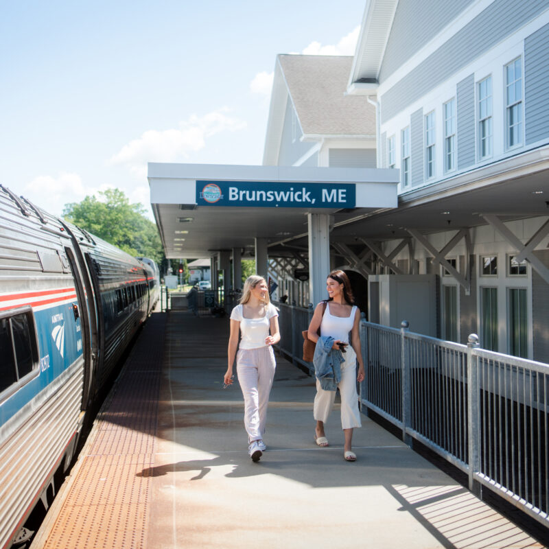 Two customers walking on the platform at the Brunswick Amtrak Station