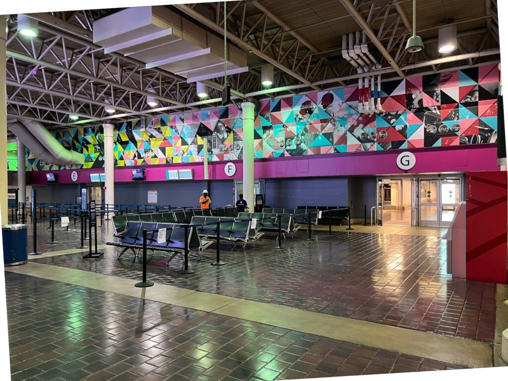 Train station with artwork on the wall.