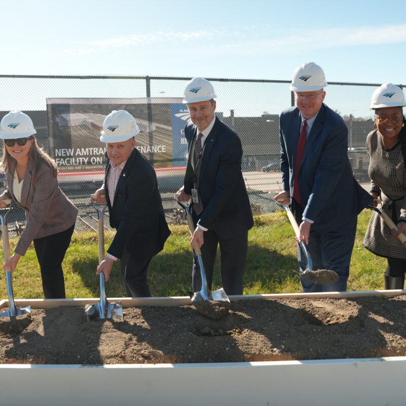 Amtrak President Roger Harris and partners hold shovels with dirt for the ceremonial groundbreaking