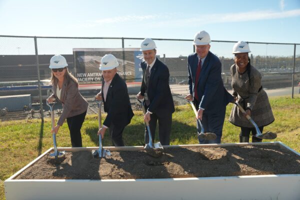 Amtrak President Roger Harris and partners hold shovels with dirt for the ceremonial groundbreaking